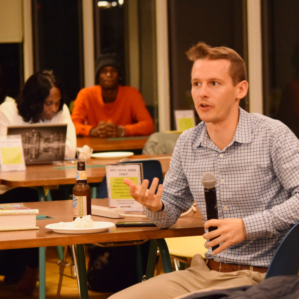 An audience member asking a question using a microphone