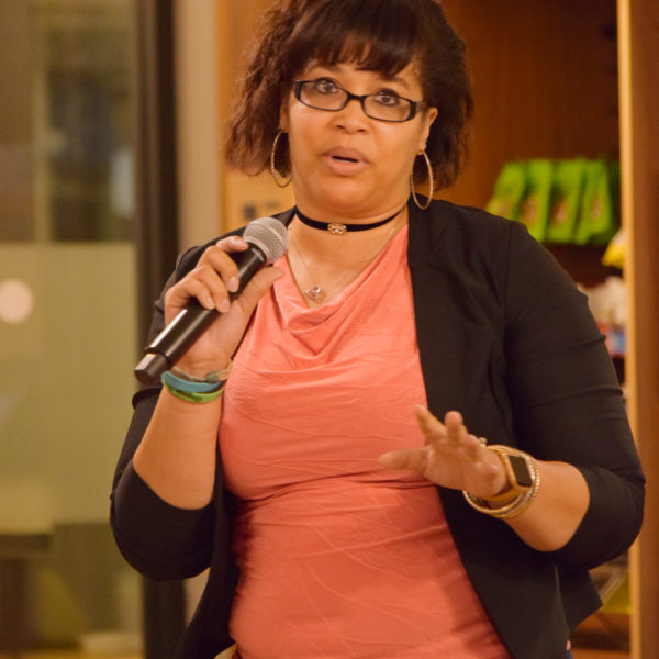 An audience member asking a question using a microphone